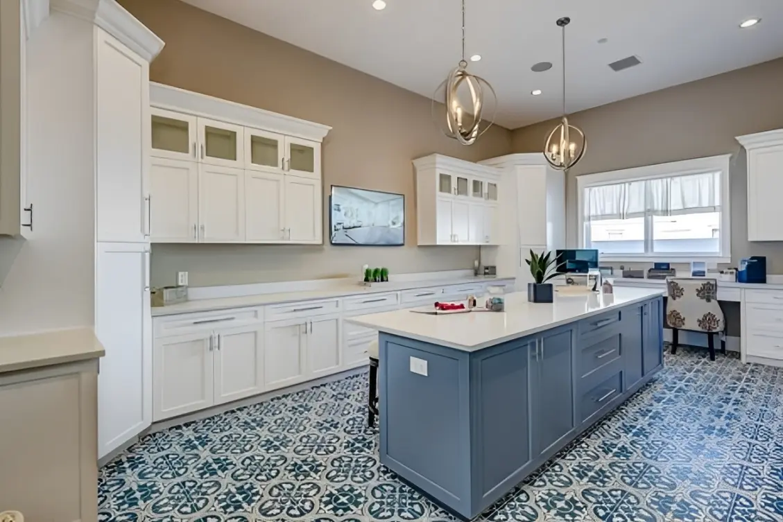 Modern kitchen with island and patterned floor.